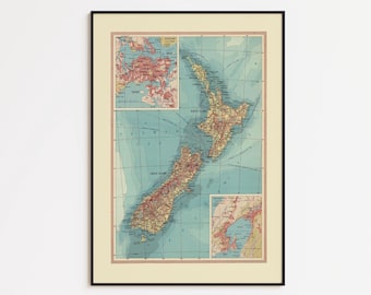 May include: Framed vintage map of New Zealand, featuring detailed land and sea color variations. The map includes inset maps of other regions, all within a black frame. The overall color palette is muted, with a focus on earth tones and blues.