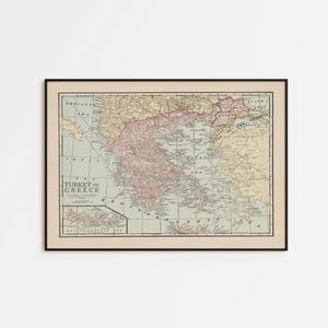 May include: Framed vintage map of Turkey and Greece, featuring a detailed cartographic representation with a color palette of beige, pink, yellow, and green. The map is enclosed in a black frame, suitable for home decor.
