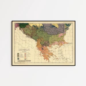 May include: A framed vintage ethnographic map of the Balkan Peninsula featuring a cream-coloured background with various regions shaded in muted tones of green, brown, pink, yellow, and blue, including a legend and the title ETHNOGRAPHIC MAP OF THE BALKAN PENINSULA.