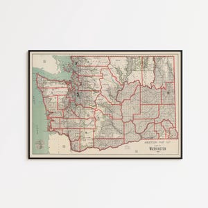 May include: Framed vintage map of Washington State, featuring a detailed depiction of counties and geographical features. The map has a black frame and is printed in muted tones of green, beige, and red. The text "ANDERSON MAP CO" and "WASHINGTON" are visible.