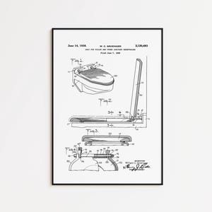 May include: Black framed patent print of a toilet seat design, dated June 14, 1938. The print includes detailed diagrams and technical drawings of the seat and its components, with the inventor's signature.