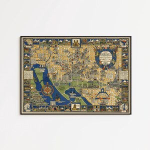 May include: A framed vintage map with a black border. The map features a detailed illustration of a city, with a blue and yellow color scheme. The map includes various landmarks and a compass rose.