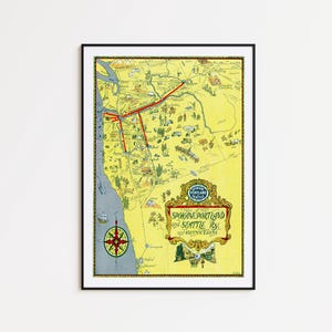 May include: A framed vintage map of the Pacific Northwest, featuring Spokane, Portland, and Seattle. The map is primarily yellow with red lines indicating routes, and includes a compass rose and decorative text. The frame is black.