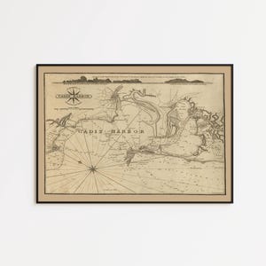 May include: Framed vintage map of Cádiz Harbor, featuring intricate details and nautical elements. The map is printed in sepia tones, with text including "CADIZ HARBOR" and a compass rose. The map is framed in a black frame.