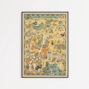 May include: A framed vintage-style illustrated map of Baltimore, Maryland, featuring a light yellow background with various landmarks, cartoon figures, and the text "Compliments of the Oriole Cafeteria" printed in the lower left corner of the print.