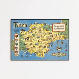 May include: A framed vintage map of Devon, England, with a blue border. The map features illustrations of landmarks and towns, with the word "Devon" at the top. The map is in a black frame.
