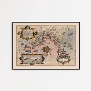 May include: A framed antique-style map print featuring the text TIERRA DEL FUEGO and AMERICA. The map displays a compass rose, nautical illustrations of sea creatures, ships, and decorative cartouches with Latin text, all set within a thin black frame.
