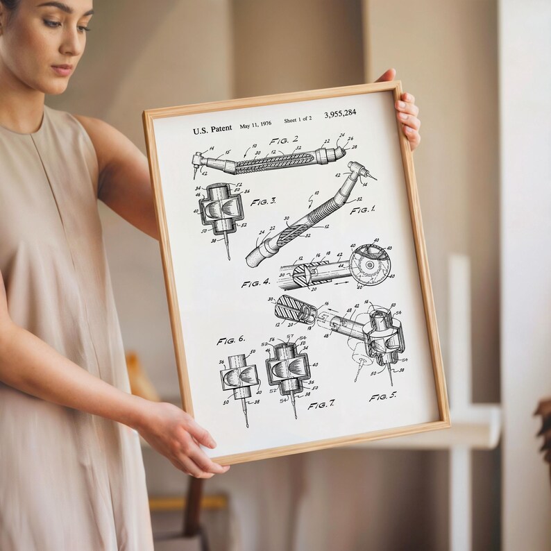 May include: A framed black and white patent print of dental tools. The print includes diagrams labeled with figures and the text "U.S. Patent May 11, 1976 Sheet 1 of 2 3,955,284". The frame is made of light-coloured wood.