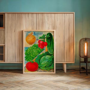 May include: A framed vintage print featuring illustrations of various vegetables, including an onion, tomatoes, lettuce, cabbage, and a cucumber. The print has the text "6 of My Leading Vegetable Specialties" and is displayed on a wooden cabinet.