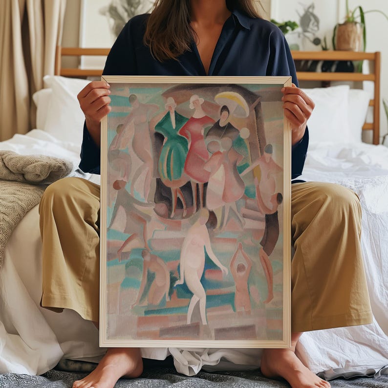 May include: A framed artwork featuring a colorful abstract depiction of figures in various poses. The artwork has a light wooden frame. The figures are painted in shades of pink, green, and blue. The artwork is held by a person.