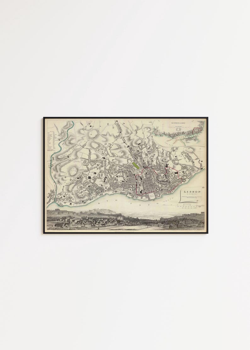 May include: A framed vintage map of Lisbon, Portugal, presented in a black frame. The map features detailed topographical lines, city streets, and a panoramic illustration of the city skyline along the bottom edge, with the text LISBON clearly visible.