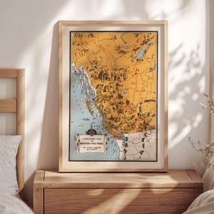 May include: A framed vintage-style illustrated map of British Columbia with a yellow landmass and blue ocean. The map features various small drawings of animals, landmarks, and activities, with a title box reading Animated Map of British Columbia.