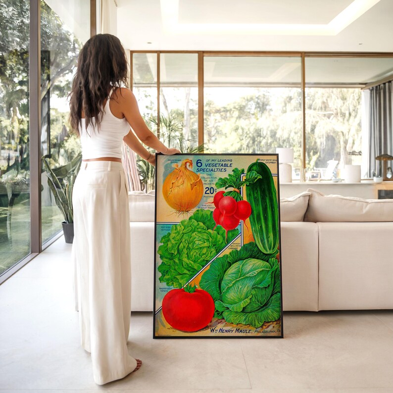 May include: A framed vintage print featuring illustrations of various vegetables, including an onion, lettuce, tomatoes, cucumber, and cabbage. The print has text that reads "6 of My Leading Vegetable Specialties" and "W. Henry Maule."