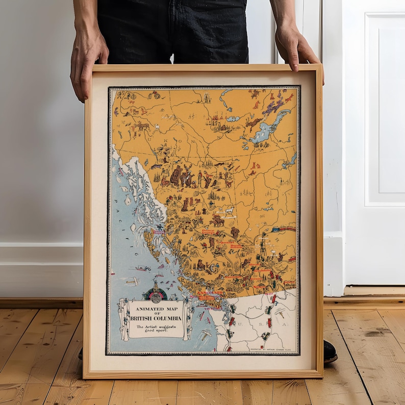 May include: A framed vintage-style illustrated map of British Columbia with a tan landmass and blue coastal waters. The map features various small drawings of wildlife, activities, and landmarks, with the text "ANIMATED MAP OF BRITISH COLUMBIA".