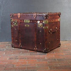 luxury hand dyed custom made leather English style travel chest, built on a solid wood frame and finished in hand dyed natural vegetable tan leather with thick trim corners and vast brass fittings.