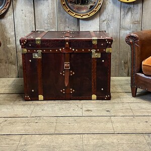 Large dark leather storage chest with antique brass fittings, corner plates and double leather carry straps, handmade in England