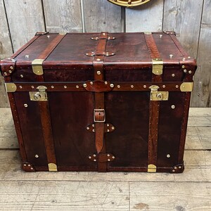 Bespoke hand dyed leather trunk with lockable brass clasp, solid corner fittings and studded leather trim, handcrafted in England