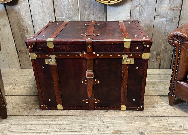 Bespoke hand dyed leather trunk with lockable brass clasp, solid corner fittings and studded leather trim, handcrafted in England