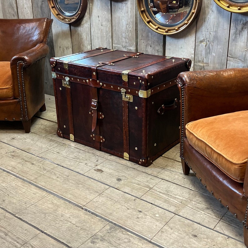 Hand dyed full-grain leather storage trunk with lockable brass clasp and buckled leather straps, crafted in England