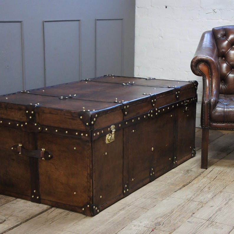 Vegetable Tan Leather Trunk Hand Dyed English Artisan Coffee Table Storage Chest Heirloom Quality Furniture Handmade Brown Chestnut Finish Warm Amber Tones Unique Character Brass Hardware Living Room Bedroom Ottoman Large Capacity Wedding