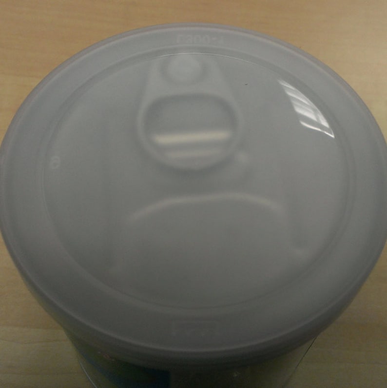 May include: White plastic lid with a pull tab for a can or jar.