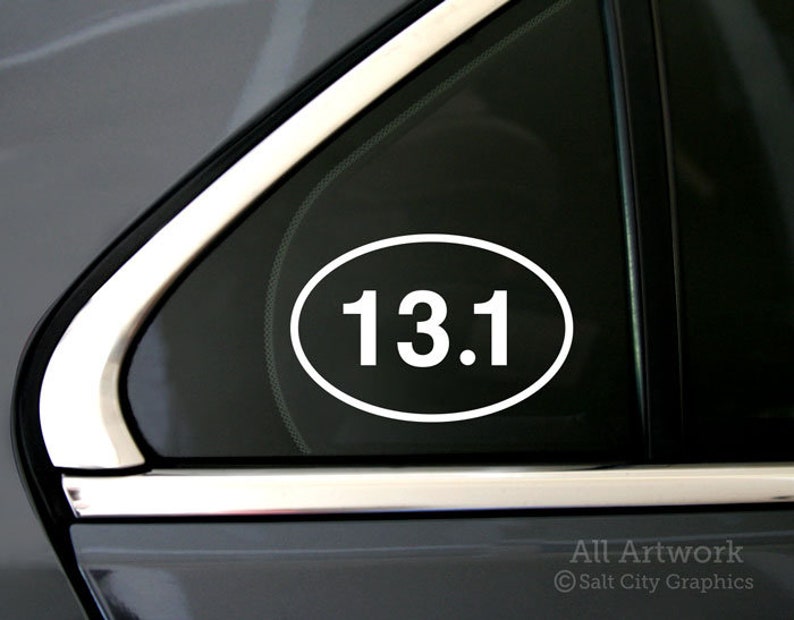 Photo of Salt City Graphics 13.1 Half Marathon decal featuring the number 13.1 inside an oval. The decal is White and shown on the rear corner of a car's passenger window. Photo and artwork copyright Salt City Graphics®.