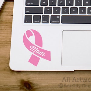 Photo of pink vinyl decal of an awareness ribbon with the word Wife cut out of front shown on laptop