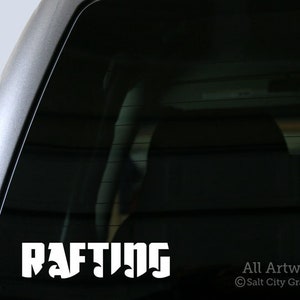 Photo of white vinyl decal of the word Rafting shown on truck window