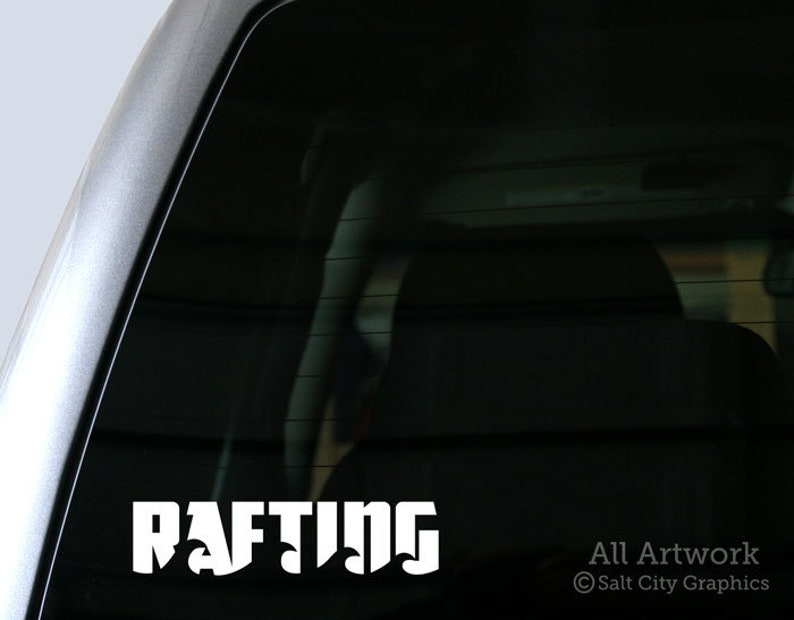 Photo of white vinyl decal of the word Rafting shown on truck window