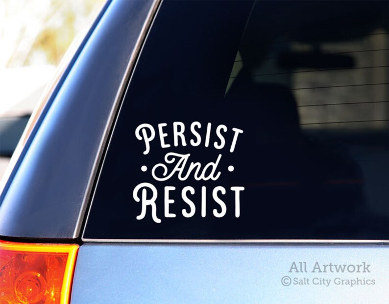 Photo of black vinyl decal of the popular phrase Persist and Resist shown on SUV window