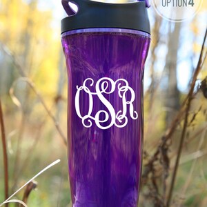 White vinyl decal of script monogram shown on purple water bottle