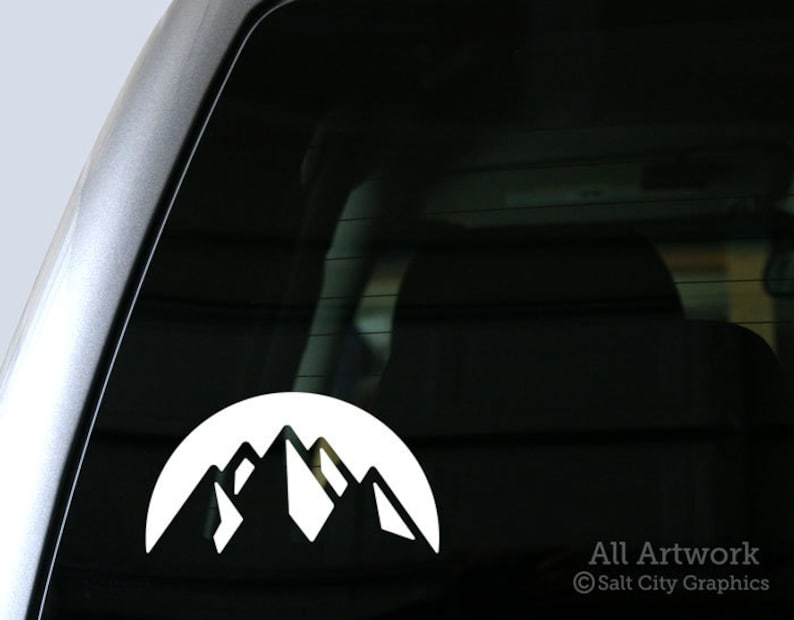 Photo of white vinyl decal of the snowy mountain range shown on truck window
