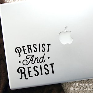 Photo of black vinyl decal of the popular phrase Persist and Resist shown on laptop