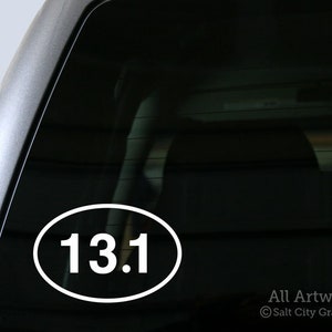 Photo of Salt City Graphics 13.1 Half Marathon decal featuring the number 13.1 inside an oval. The decal is White and shown on the bottom left corner of a truck's rear window. Photo and artwork copyright Salt City Graphics®.