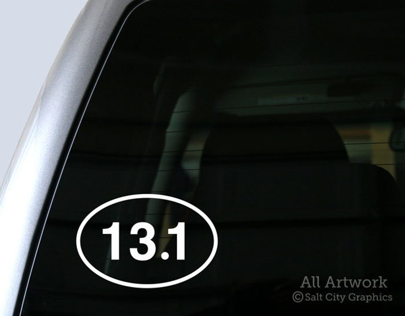 Photo of Salt City Graphics 13.1 Half Marathon decal featuring the number 13.1 inside an oval. The decal is White and shown on the bottom left corner of a truck's rear window. Photo and artwork copyright Salt City Graphics®.