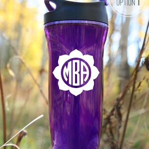 White vinyl decal of flower circle monogram shown on purple water bottle
