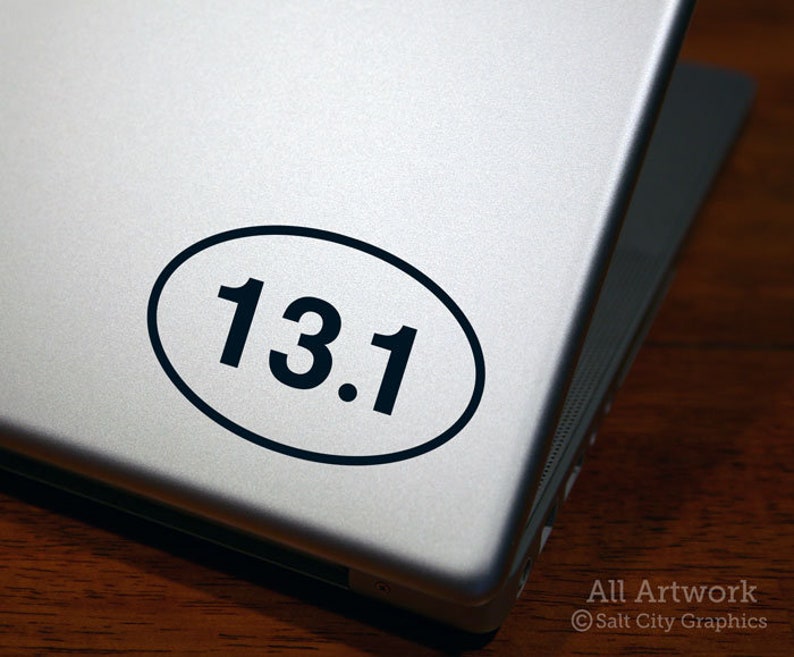 Photo of Salt City Graphics 13.1 Half Marathon decal featuring the number 13.1 inside an oval. The decal is Black and shown on the bottom right of a silver laptop lid. Photo and artwork copyright Salt City Graphics®.