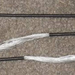 May include: A black and silver bowstring for archery. The string is made of a braided material with a black core and silver outer layer.