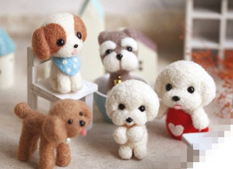 May include: Five needle felted dog figurines. The dogs are brown, white, and gray. They are all sitting or standing on a white surface.