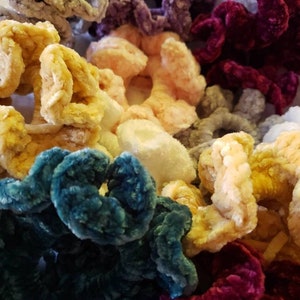 Puede incluir: Una colecci&oacute;n de scrunchies peludos de colores en varios tonos de rosa, amarillo, azul, morado y rojo. Los scrunchies est&aacute;n hechos de un material suave y aterciopelado y son perfectos para agregar un toque de color y estilo a cualquier peinado.