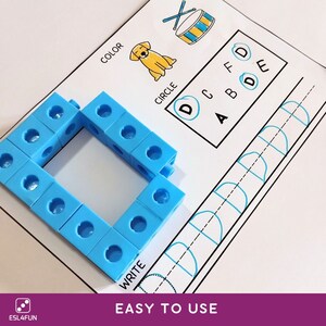 May include: A printable worksheet for learning the letter D. The worksheet features a blue letter D made of blocks, a picture of a dog, and a circle around the letter D. The worksheet also includes a section for tracing the letter D.