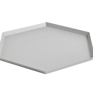 May include: A light gray, pentagon-shaped tray with a raised edge. The tray has a simple, modern design and is made of a solid, opaque material. The tray is empty and sits against a white background.