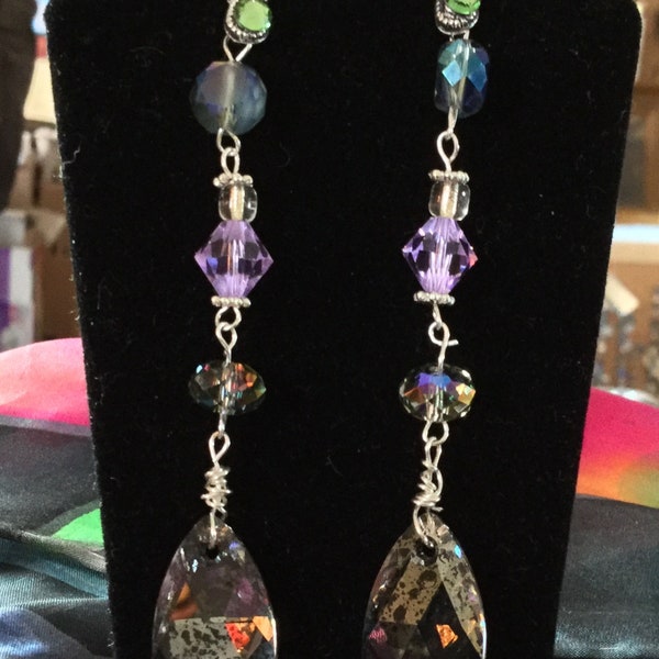 Earrings.  Dripping with smokey Swarovski crystals, these earring are sure to become your favorite! Hollywood look, fraction of the cost!