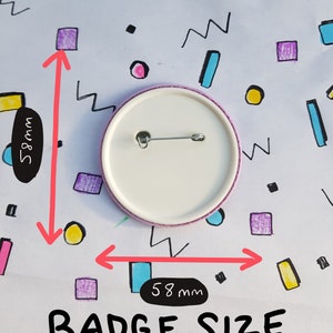 May include: A white round badge with a pin on the back. The badge is 5.8 inches in diameter.