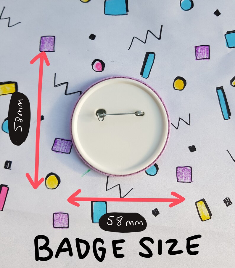 May include: A white round badge with a pin on the back. The badge is 5.8 inches in diameter.