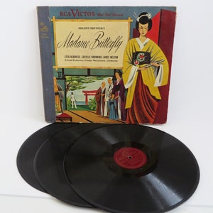 May include: A vintage RCA Victor record album cover featuring a colorful illustration of a woman in a kimono, with the title "Madame Butterfly" and the names of the performers: Licia Albanese, Lucielle Browning, and James Melton. The album is a recording of highlights from Puccini's opera.