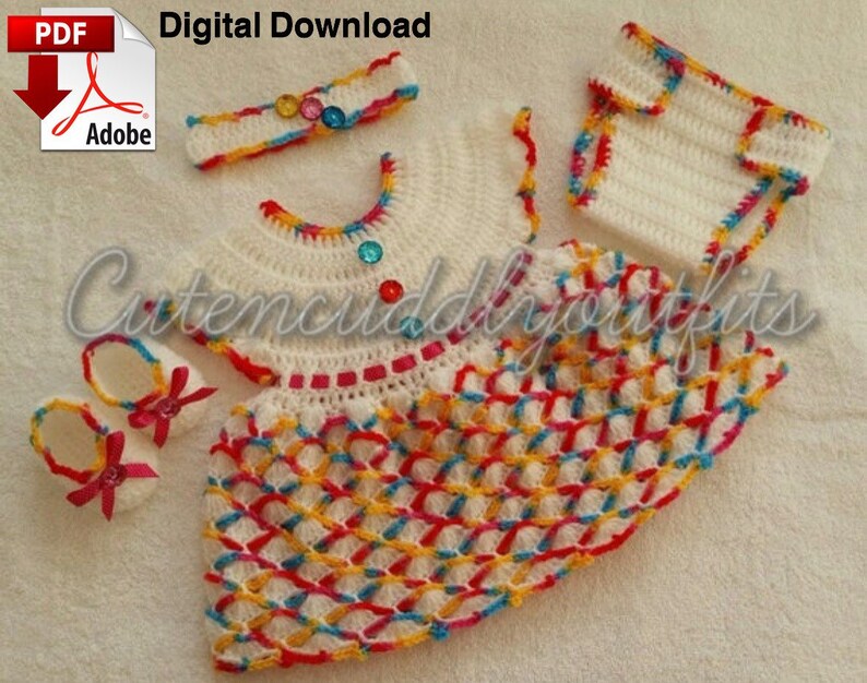 May include: A crochet baby outfit set in white with colorful accents. The set includes a dress, headband, diaper cover, and booties. The dress has a colorful crocheted pattern and is decorated with rhinestones. The headband is also crocheted and has rhinestones. The diaper cover is white with colorful crocheted trim. The booties are white with pink bows.