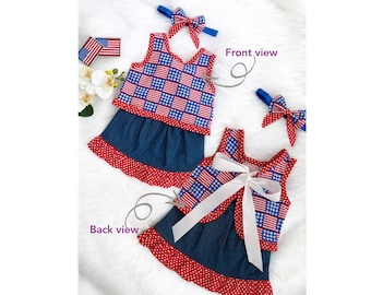 May include: A patriotic outfit featuring a top and skirt with a red, white, and blue American flag pattern. The skirt is denim with a red polka dot trim. Includes a matching headband with a bow. "Front view" and "Back view" are labeled.