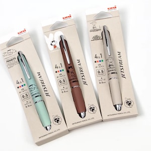 May include: Three Uni Jetstream 4+1 multi-pens with Peanuts characters. The pens are in brown, beige, and light blue with silver accents. Each pen has a 0.5 mm ballpoint and a 0.5 mm mechanical pencil.