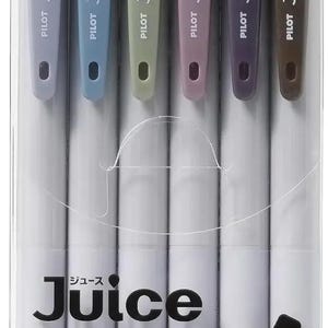 May include: A set of six Pilot Juice 0.5 gel ink pens in ash colors, packaged in a clear plastic case. The pens feature muted tones including gray, blue, green, mauve, purple, and brown, with the text Juice and Japanese characters visible.